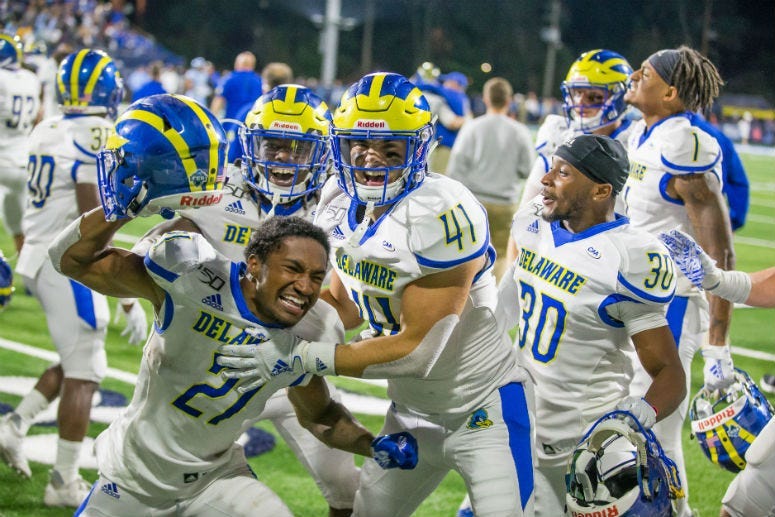 Delaware football players celebrates last week's triple-overtime win at Rhode Island.