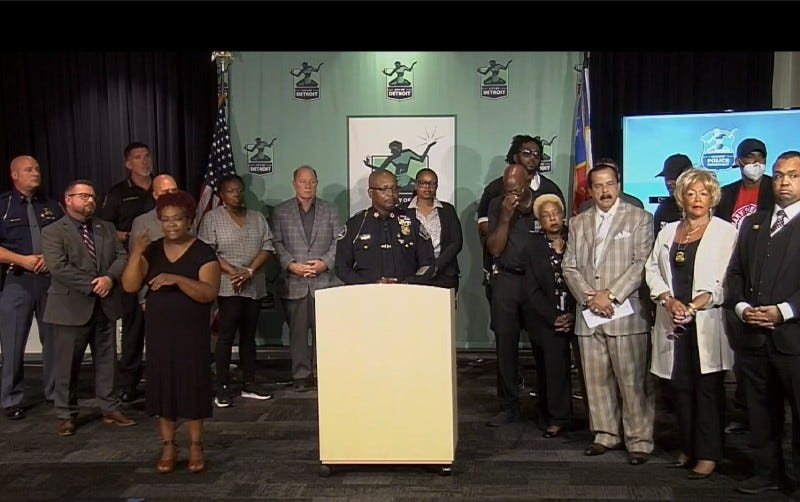Detroit Police Department press conference. Police Chief White, Mayor Duggan and law enforcement leaders / partners stand on stage in front of speaker's podium.
