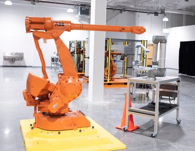 The robotics training area is designed with maximum flexibility; robot cells are on self-contained pallets that can be easily moved and plugged into an overhead electrical outlet.