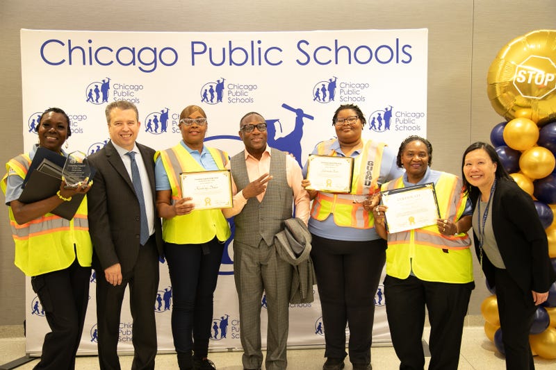 Chicago Public Schools' four "Crossing Guards of the Year" pose for a photo alongside district leaders.