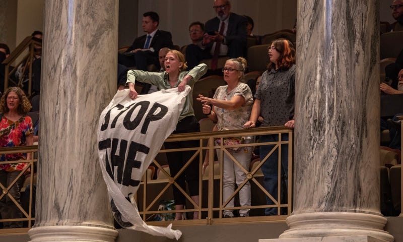 Jaeda Roth and other protestors from Abortion Action Missouri unfurl “Stop the Ban” banners as the Missouri Senate passes a proposed constitutional amendment to ban abortion.