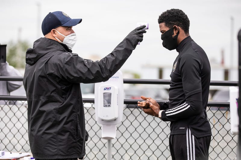 Philadelphia Union players get their temperatures taken before heading into training sessions