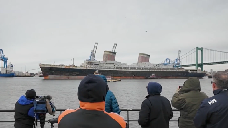 People hope to catch one last look at the SS United States as it sails down the Delaware River on its way out of Philadelphia.