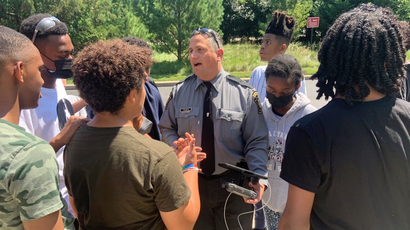 Pennsylvania State Trooper Jim Trumpio talking to students at a STEM camp at Lower Merion High School.