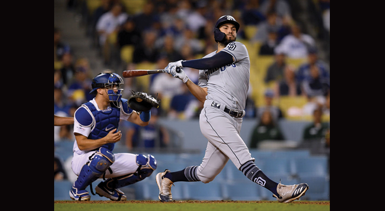 MAY 14: Eric Hosmer #30 of the San Diego Padres swings and misses at the plate in front of Austin Barnes #15 of the Los Angeles Dodgers at Dodger Stadium on May 14, 2019 in Los Angeles, California. (Photo by Harry How/Getty Images)
