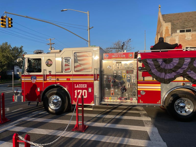 A truck from Ladder Co. 170 adorned with bunting and firefighter Timothy Klein's name outside the Church of Saint Francis DeSales on Friday morning