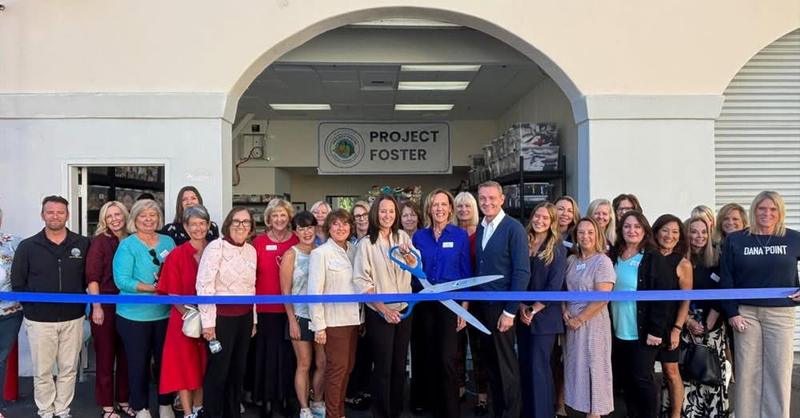 Ribbon Cutting of the non-profit's new warehouse. Center - Debby Thrialkill, along with members of the Dana Point Women's Club.
