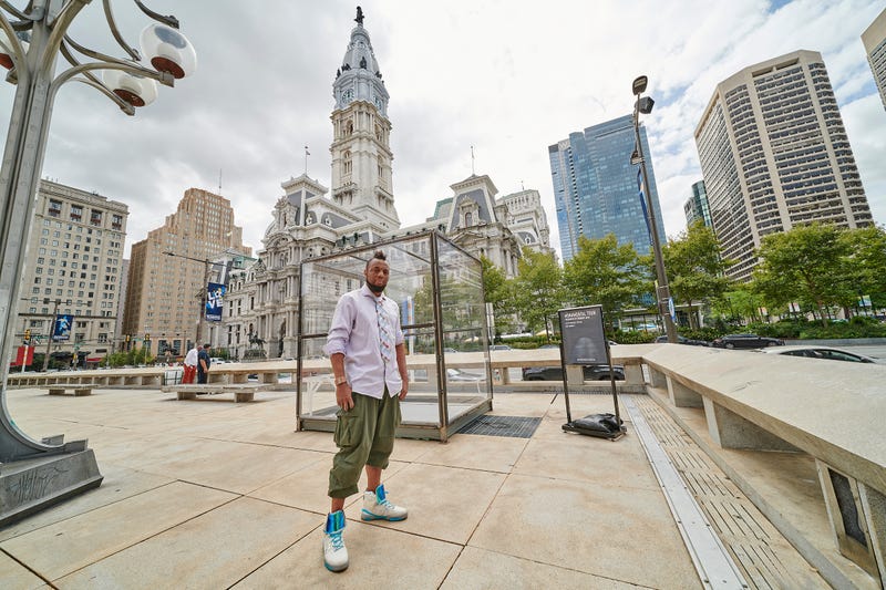 Artist Coby Kennedy with his sculpture, called "Kalief Browder: The Box," in front of the Municipal Services Building in Center City.