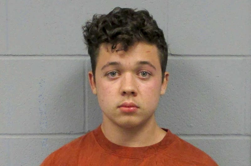 This undated booking photo from the Antioch, Ill., Police Department shows Kyle Rittenhouse. Prosecutors asked a judge Wednesday, Feb. 3, 20201, for a new arrest warrant for Rittenhouse, the Illinois teen charged with shooting three people, killing two of them, during a protest over police brutality in Wisconsin, after he apparently violated his bail conditions.