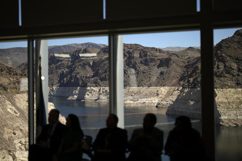 Officials listen during a news conference on Lake Mead at the Hoover Dam Tuesday, April 11, 2023, near Boulder City, NV