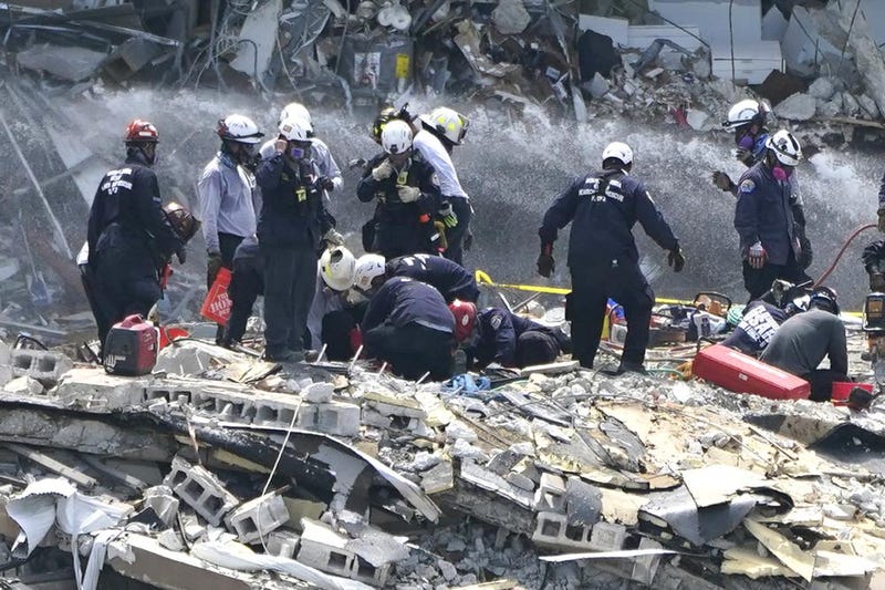 Rescue workers search the rubble of the Champlain Towers South condominium, Saturday, June 26, 2021, in the Surfside area of Miami. The building partially collapsed on Thursday.
