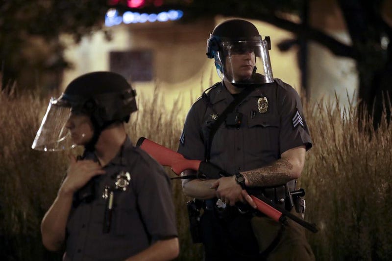 FILE - A Kansas City policeman holds a non-lethal weapon as he watches protesters June 3, 2020, in Kansas City, MO