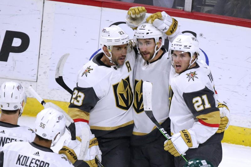 Vegas Golden Knights center Nicolas Roy (10) is congratulated on his goal by Alec Martinez (23) and Brett Howden (21) during the first period of an NHL hockey game Thursday, Feb. 9, 2023, in St. Paul, Minn.