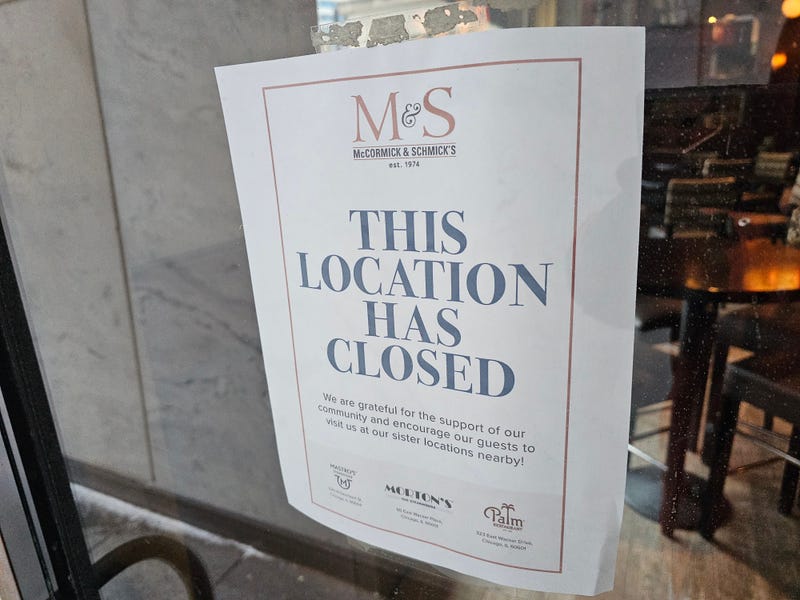 The abrupt closure of McCormick & Schmick’s at 1 E. Wacker Drive in Chicago’s Loop is marked by a sign on the door that reads in large blue letters, ‘This Location Has Closed’.