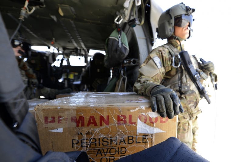 U.S. Army Spc. Robert Moher, 159th Combat Aviation Brigade crew chief, stands by to deliver blood in Afghanistan, July 2014. Moher, a Harlem, N.Y. native, is deployed from Fort Campbell, Ky. Joint Theater Trauma System members ensure fresh blood is always on hand.