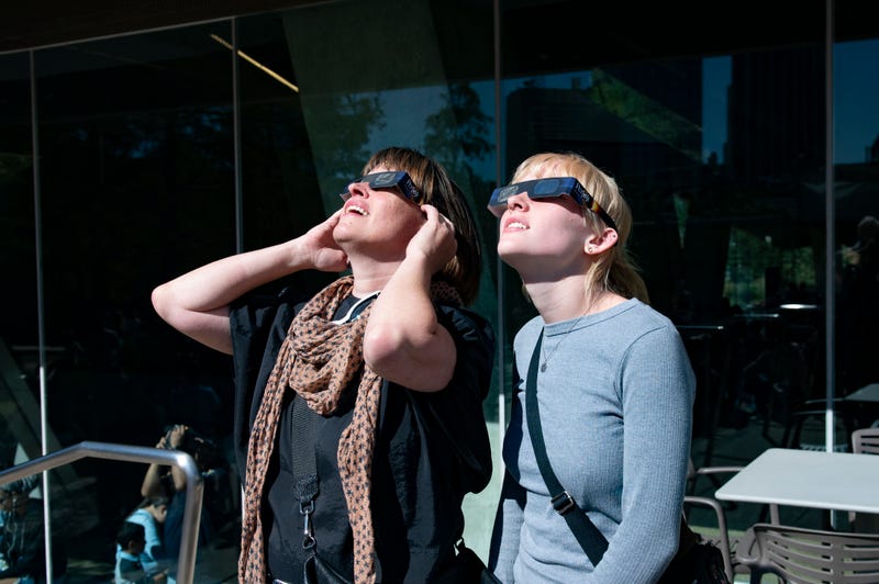 People where eclipse glasses at the Perot Museum of Nature and Science in Dallas, Texas.