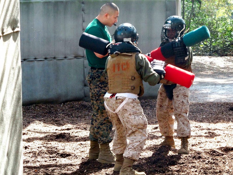 Female recruits battle with pugil sticks during training at the Marine Corps Training Depot