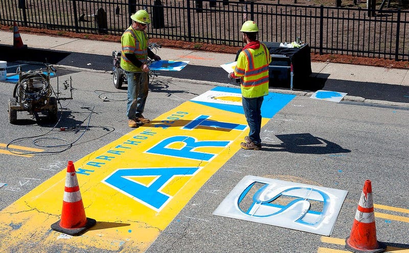 Will Belazoos, left, and Connor Freitas, of Road Safe Traffic Systems, paint the starting line Thursday, April 11, 2019, in Hopkinton, Mass., for the 123rd running of the Boston Marathon. The marathon is scheduled for Monday, April 15.