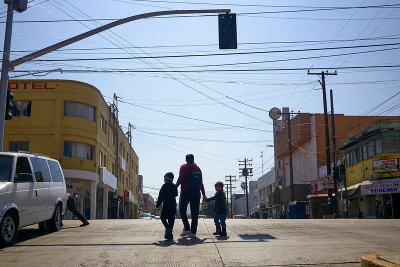 Ruth Aracely Monroy walks with her sons in Tijuana, Mexico
