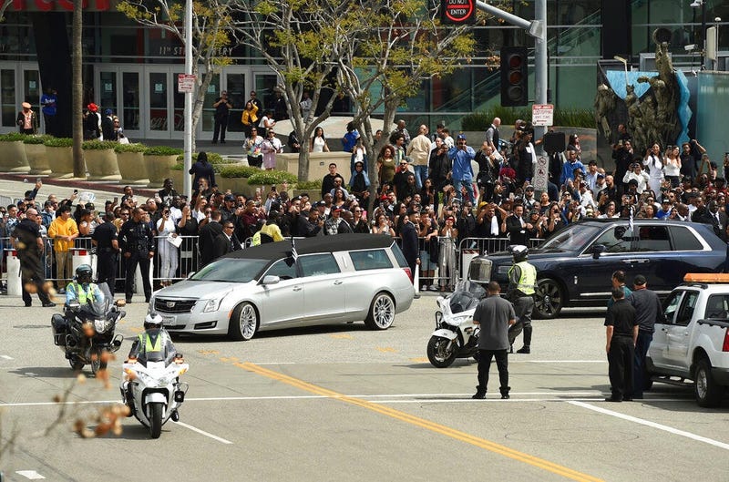 A silver hearse carrying the body of Nipsey Hussle, whose given name was Ermias Asghedom, leaves Staples Center in a procession following the Celebration of Life memorial service for the late rapper on Thursday, April 11, 2019, at the Staples Center in Lo