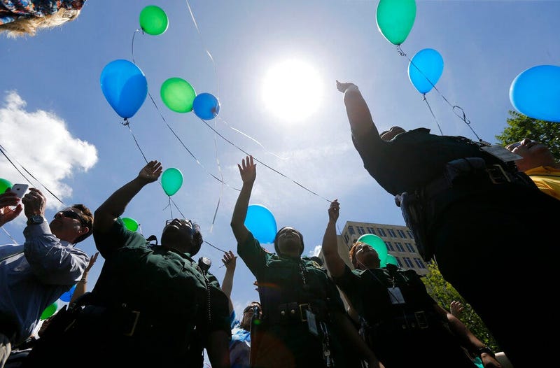 East Baton Rouge Sheriff's deputies release balloons at a noon vigil organized by municipal court workers in downtown Baton Rouge, La., in honor of slain and injured sheriff deputies and police. Bills are pending in a growing number of states in 2019 to b