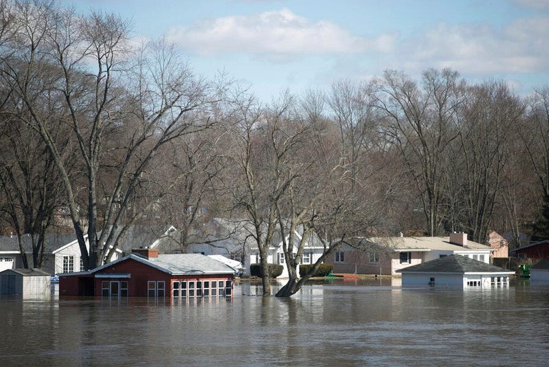 The Rock River crested its banks and floods Shore Drive, seen here on Saturday, March 16, 2019, from the Bauer Parkway bridge in Machesney Park, Ill. Many rivers and creeks in the Midwest are at record levels after days of snow and rain
