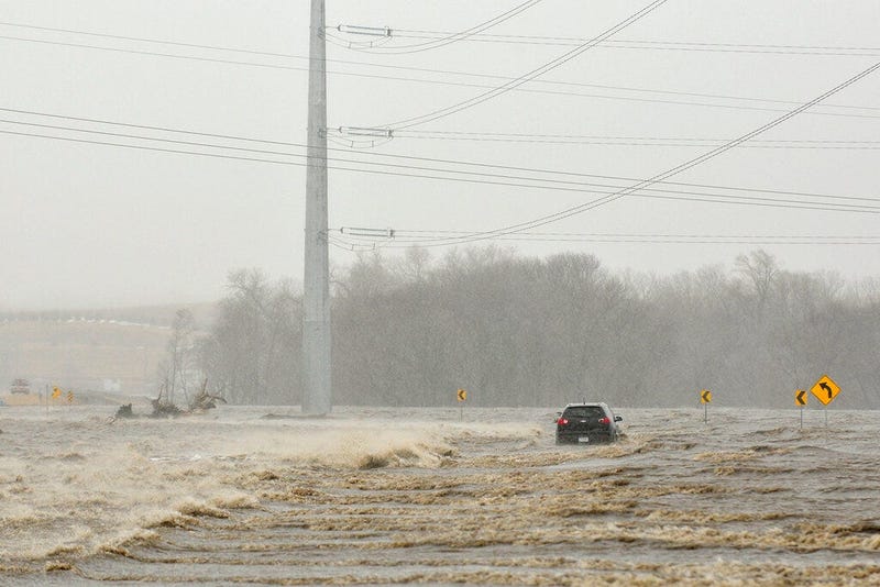  photo an abandoned car sits on Industrial Highway in flood waters north of Norfolk, Neb