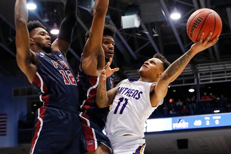 Prairie View A&M's Dennis Jones (11) shoots against Fairleigh Dickinson's Mike Holloway Jr., center, and Kaleb Bishop (12) during the second half of a First Four game of the NCAA college basketball tournament, Tuesday, March 19, 2019, in Dayton, Ohio