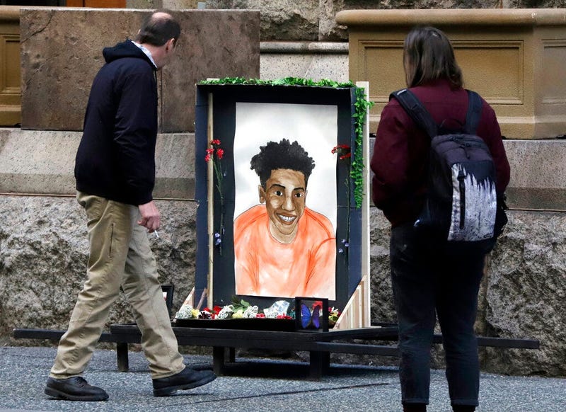 Passers-by looks at a memorial display with a drawing of Antwon Rose II in front of the Allegheny County courthouse on the second day of the trial for Michael Rosfeld, a former police officer in East Pittsburgh