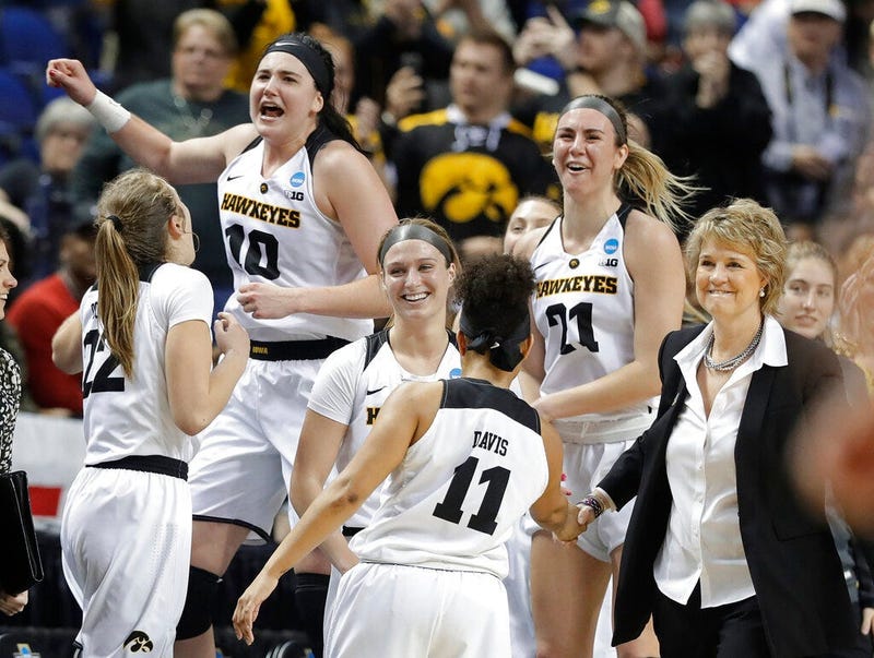 Iowa players including Megan Gustafson (10) and Hannah Stewart (21) celebrates in the closing seconds of the second half of a regional women's college basketball game against North Carolina State in the NCAA Tournament in Greensboro, N.C., Saturday, March