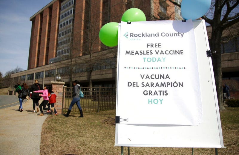 A sign advertising free measles vaccines is displayed at the Rockland County Health Department in Pomona, N.Y., 