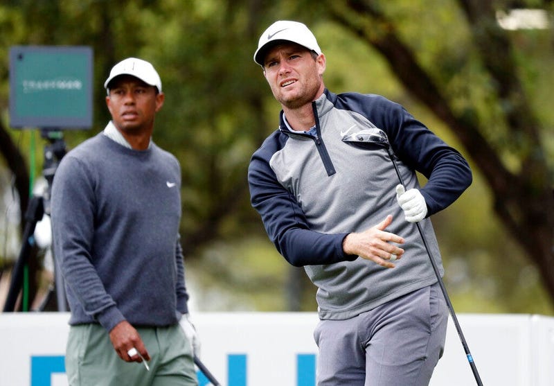 Lucas Bjerregaard, right, watches his drive on the eighth hole as Tiger Woods, left, looks on during quarterfinal play at the Dell Technologies Match Play Championship golf tournament, Saturday, March 30, 2019, in Austin, Texas. Bjerregaard won the match.