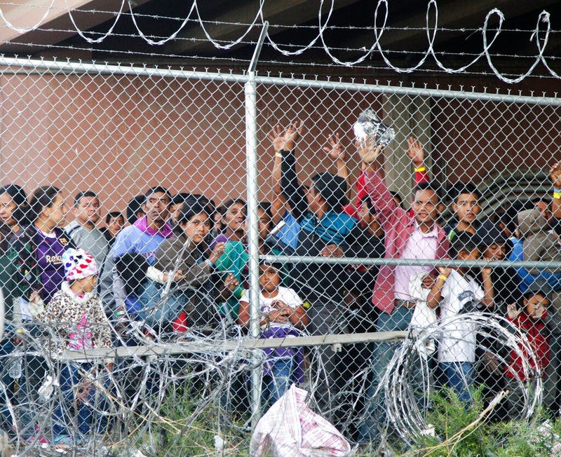 Central American migrants wait for food in El Paso, Texas, Wednesday, March 27, 2019, in a pen erected by U.S. Customs and Border Protection to process a surge of migrant families and unaccompanied minors.