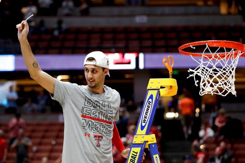 Texas Tech guard Davide Moretti holds up a piece of the net after the team's win over Gonzaga in the West Regional final in the NCAA men's college basketball tournament Saturday, March 30, 2019, in Anaheim, Calif. Texas Tech won 75-69.