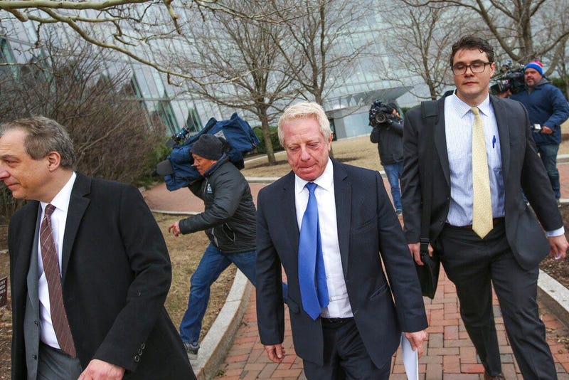 Robert Flaxman, center, founder and CEO of Crown Realty & Development, leaves leaves the federal courthouse after a hearing associated with the college admissions bribery scandal, Friday, March 29, 2019 in Boston. 