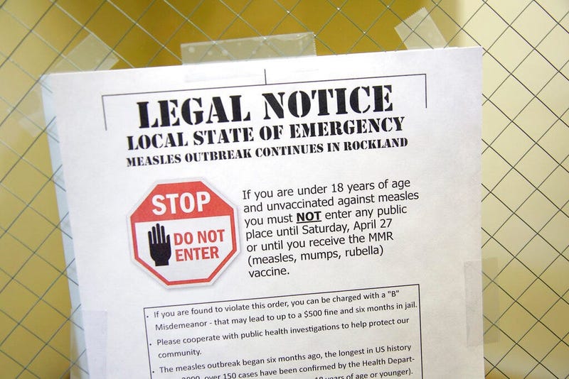 March 27, 2019 file photo shows a sign explaining the local state of emergency because of a measles outbreak at the Rockland County Health Department in Pomona, N.Y. 