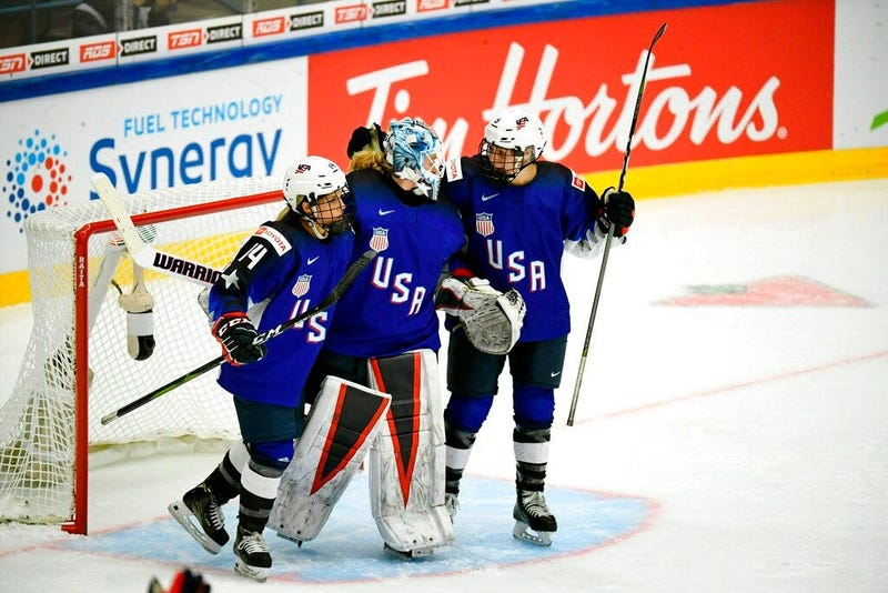 Brianna Decker, left, Alex Rigsby and Cayla Barnes of USA celebrate winning the 2019 IIHF Women's World Championships preliminary match between USA and Canada in Espoo, Finland, Saturday April 6, 2019. 