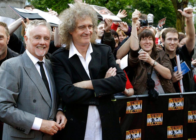 members of the rock band Queen, Roger Taylor, front left, and Brian May, front right,