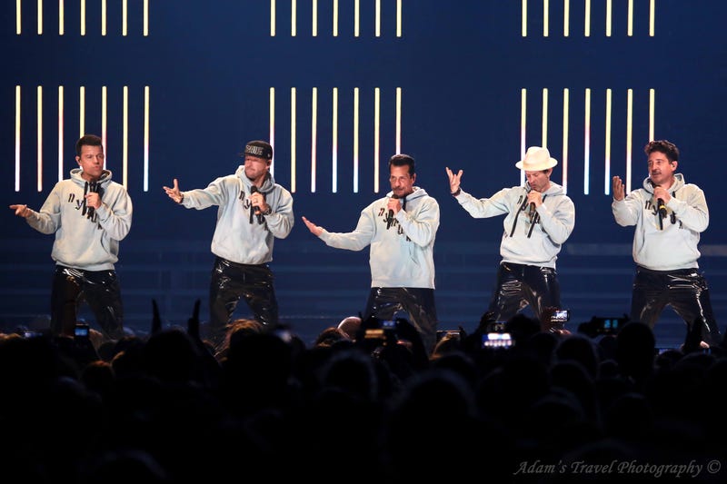New Kids on the Block on stage in grey hoodies