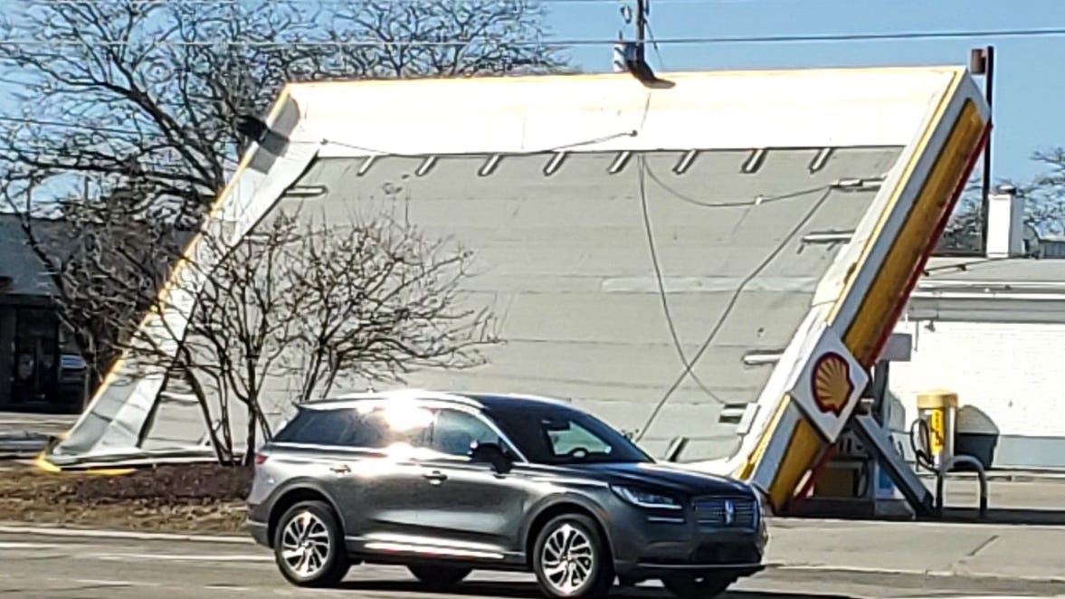 Gas station awning brought down by high winds as thousands of Metro Detroiters lose power