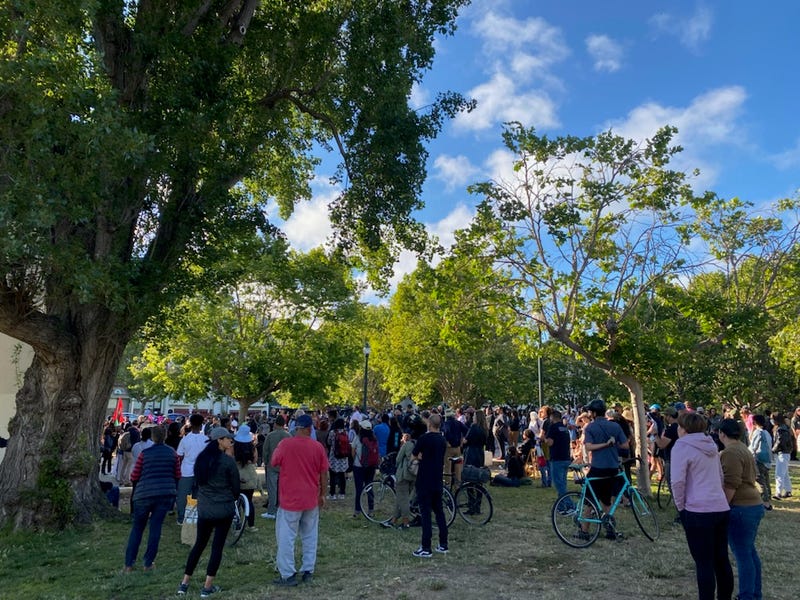 A few hundred people gather for a vigil at Lake Merritt on Tuesday following the Juneteenth mass shooting.