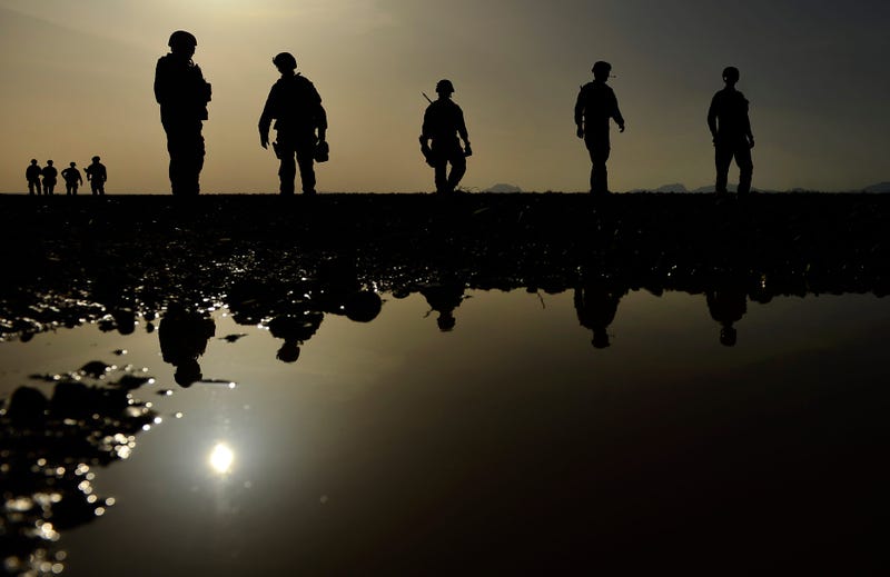 Explosive Ordnance Disposal technicians assigned to the 466th Air Expeditionary Squadron, walk toward a blast pit after detonating four 500-pound bombs