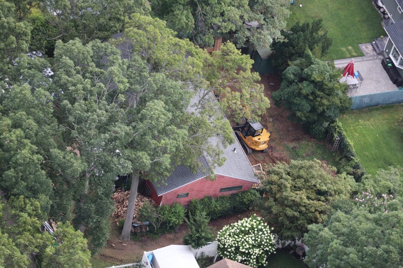 The excavator was brought in over the weekend to dig in the backyard