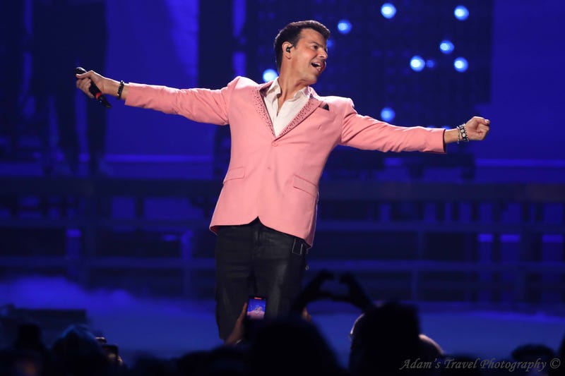Man in pink suit on stage