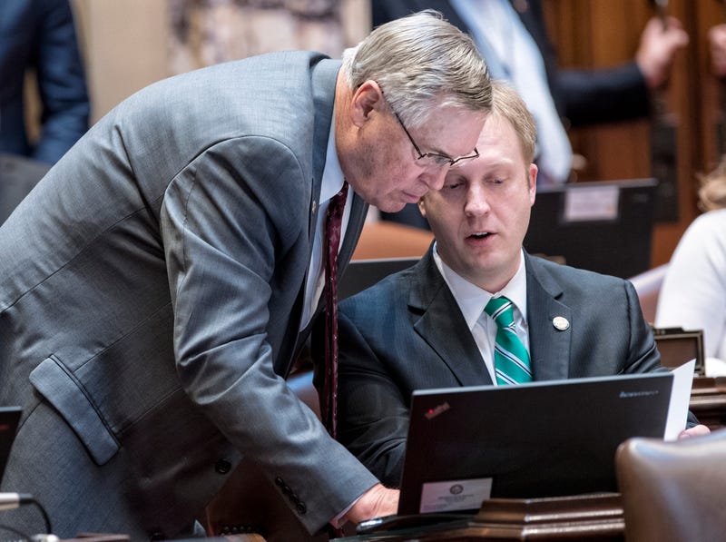 Former Republican State Senator Justin Eichorn (right) discusses senate business during a floor session prior to his resignation after charges were filed in an underage prostitution ring in Bloomington.