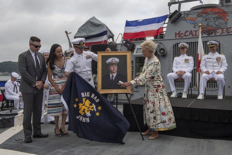 Cindy McCain is presented with a painting of her husband during the 25th anniversary of the ship's commissioning
