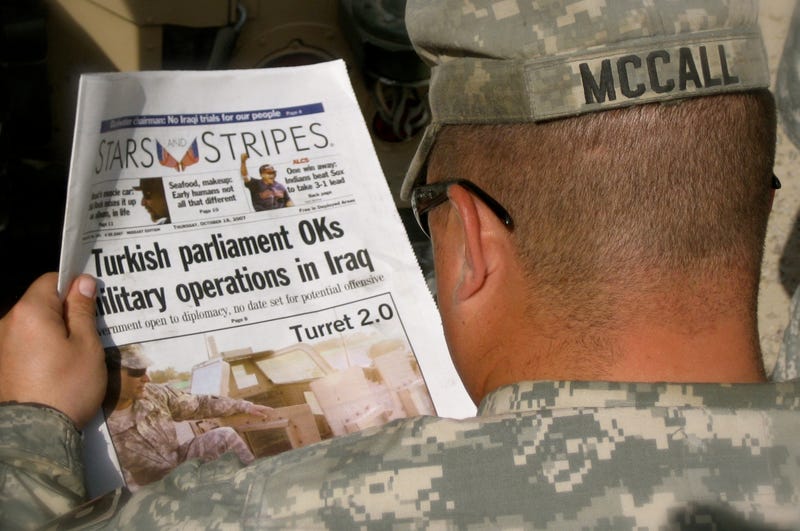 File photo: U.S. Army Sgt. Roger McCall, 153rd Military Police Company, reads an edition of the Stars and Stripes newspaper while in the Green Zone, Baghdad, Oct. 18, 2007.