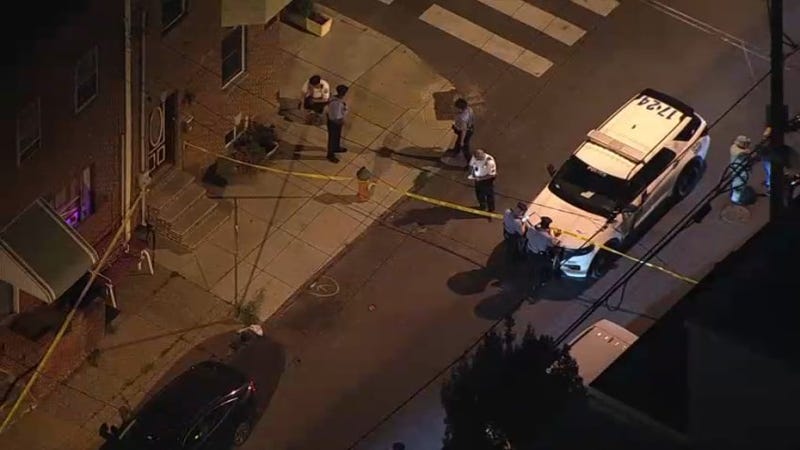Police investigate the scene of a Friday night shooting in Point Breeze.