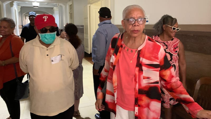 Brith Sholom House tenants stand outside the courtroom where a Common Pleas judge approved the sale of the building to PHA.