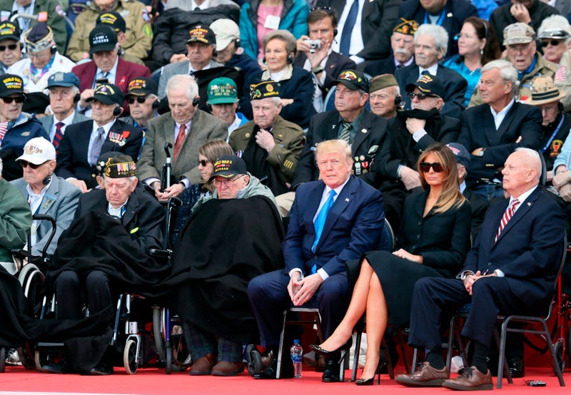 U.S. World War II veteran Jacques Michienzi, center, stands up among other veterans during a ceremony to mark the 75th anniversary of D-Day at the Normandy American Cemetery.
